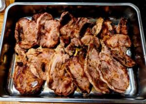 En plåt med grillad fläskkarré som är gyllenbrun och välstekt.