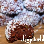 Chokladbollar täckta med kokos, en av dem är delvis tuggad.